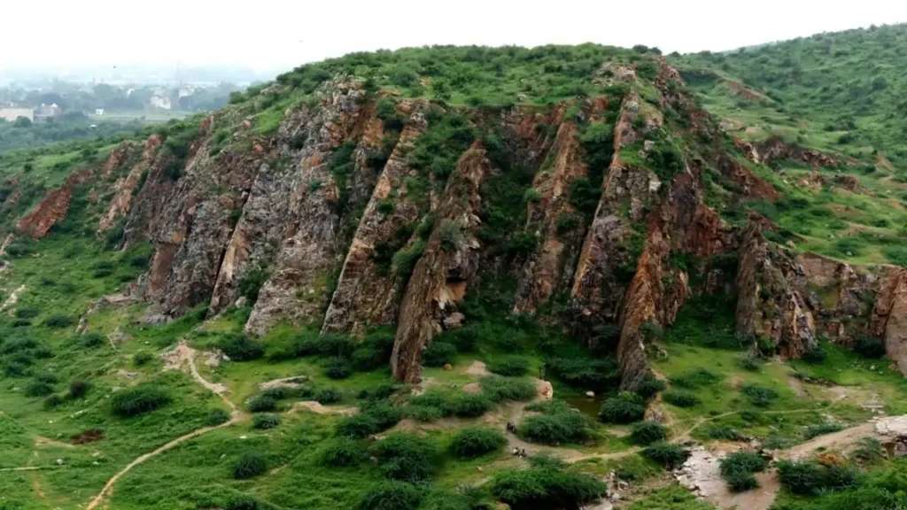 Aerial view of Aravalli Hills Rajasthan showing green hills, rocky terrain, and valleys