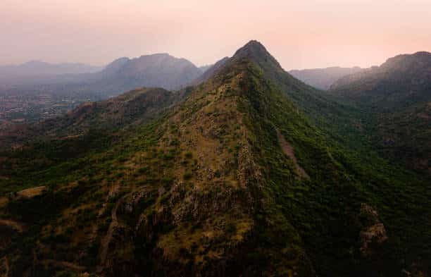 Aravalli Hills Rajasthan aerial view showing lush green hills and rocky terrain