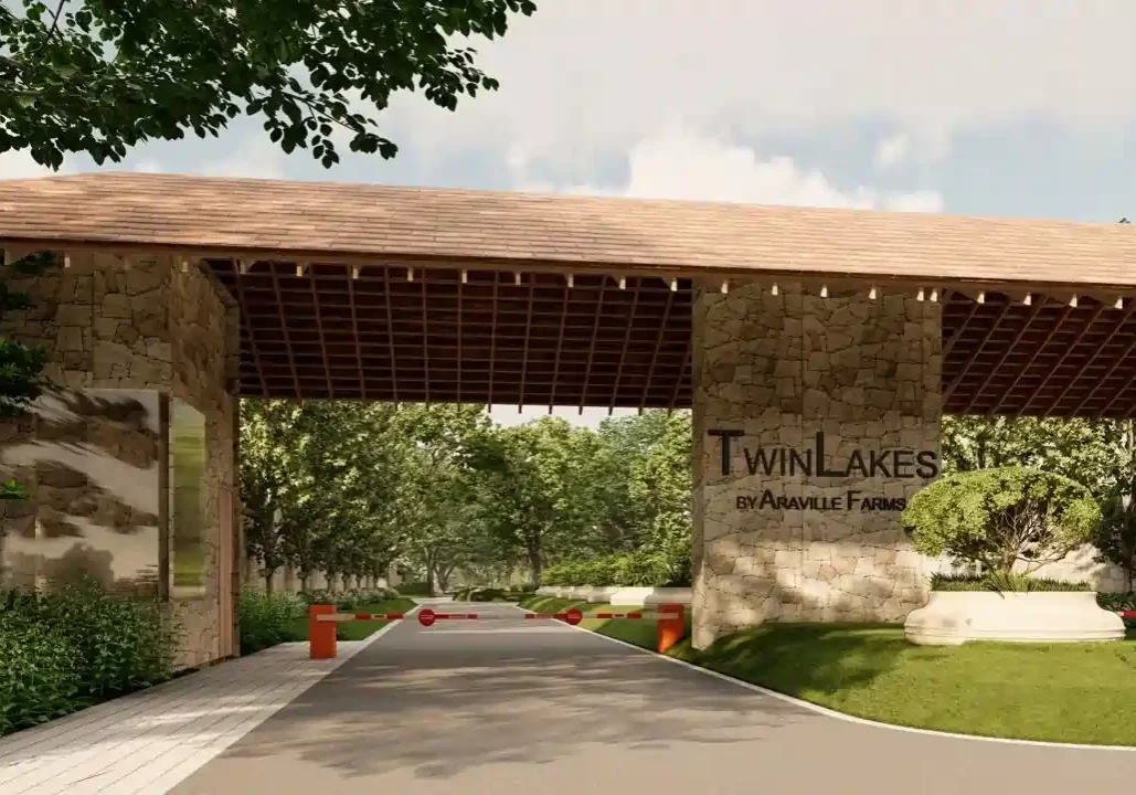 Twin lakes surrounded by green farmland and trees at Twin Lakes Farms in Naugaon, offering a peaceful and scenic view.